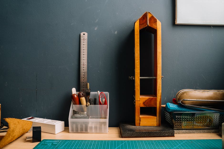 A neat workbench setup featuring various tools, a ruler, and organized storage.